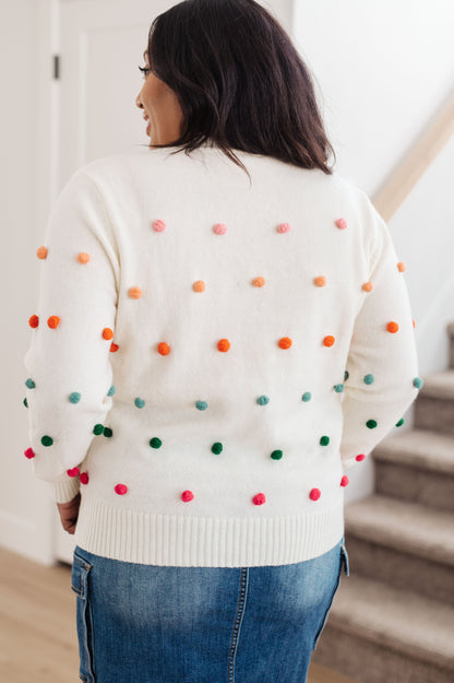 Suéter con detalle de pompones y botones de caramelo (exclusivo en línea)